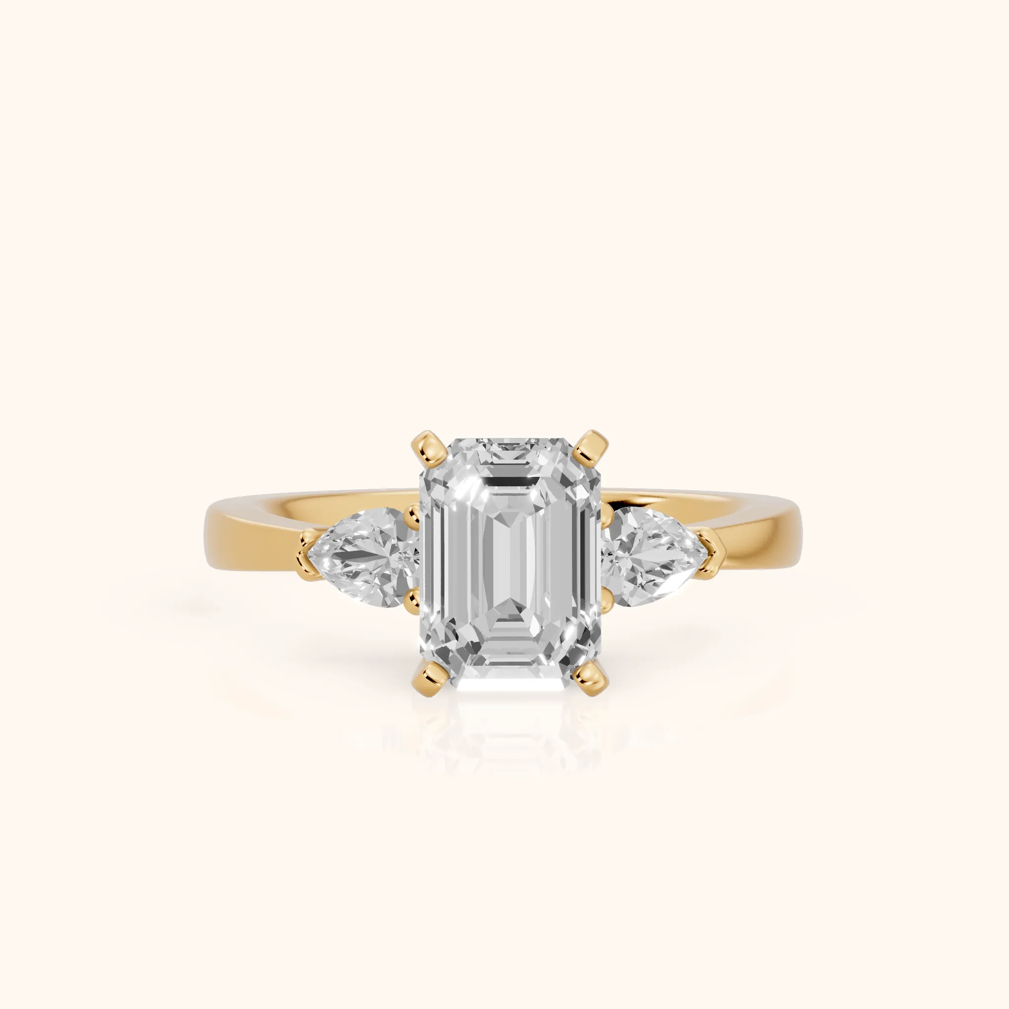 Amabel Three-Stone Emerald Diamond Engagement Ring in Yellow Gold — view 1