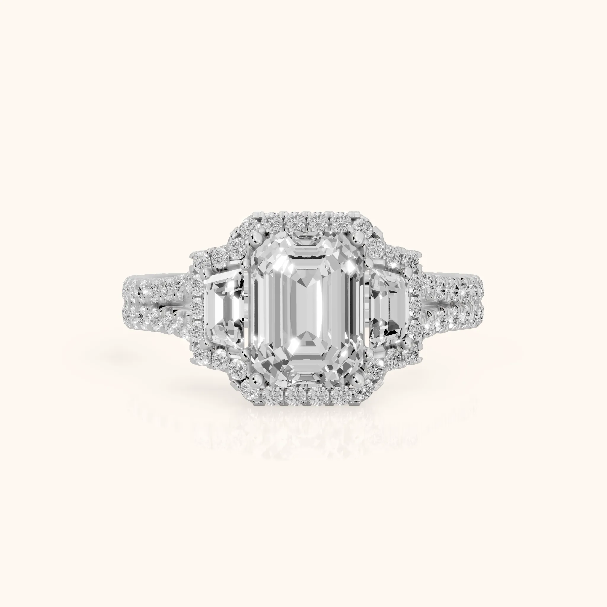 Ronan Three-Stone Halo Emerald Diamond Engagement Ring in Platinum — view 1
