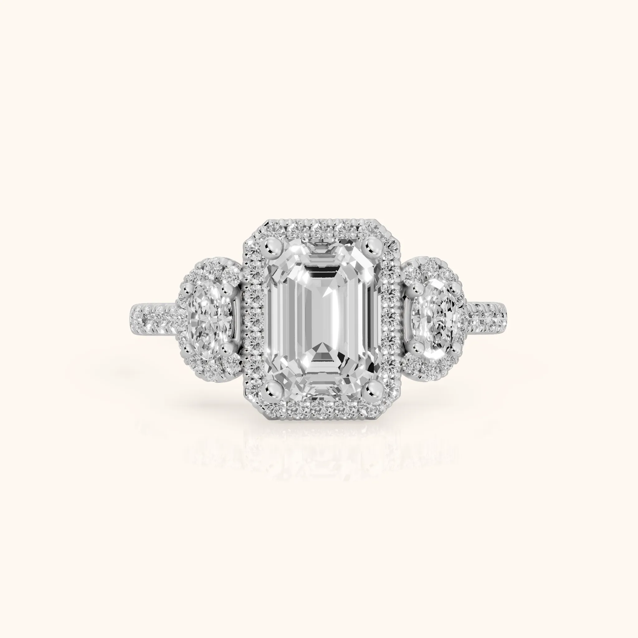 Austin Three-Stone Halo Emerald Diamond Engagement Ring in White Gold — view 1